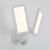 A modern white LED security light fixture with two rectangular adjustable panels, mounted on a wall, featuring a motion sensor at the base.