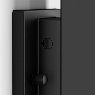 Close-up view of the Artika Linea Square LED indoor-outdoor wall light 3 CCT, a black fixture with a round button and textured knob, mounted against a white and gray background.