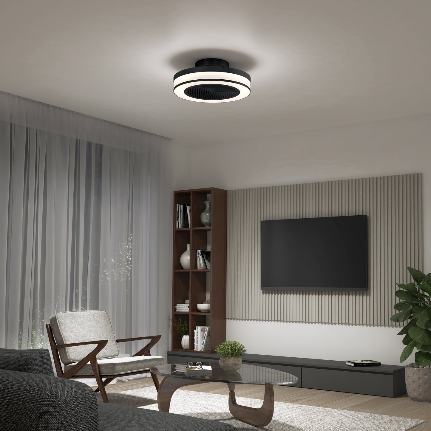 Modern living room featuring a gray armchair, coffee table, wall-mounted TV, bookshelf, large window with sheer curtains, and the Artika Elton 19.4 in. LED modern ceiling fan with 3 speeds and remote control.