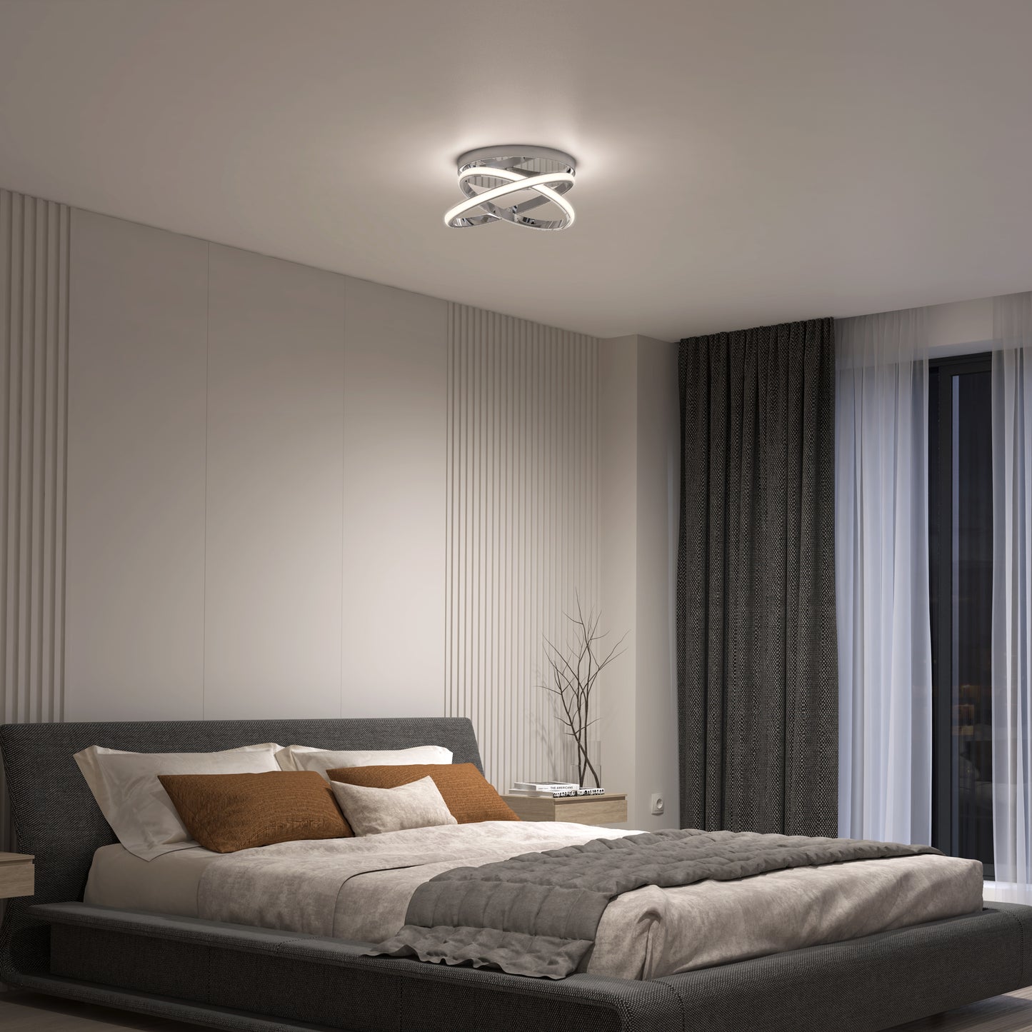 A modern bedroom features a gray bed, beige and brown bedding, two wooden nightstands—one with a minimalist plant—and floor-to-ceiling curtains. The Artika Orbia modern LED flush mount light (3 CCT) adds a contemporary touch overhead.