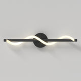 A modern wall light with a black circular base and a horizontal black bar, featuring a glowing white LED tube twisted in a wave pattern around the bar, mounted on a plain light-colored wall.