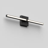 A modern, minimalist wall-mounted LED light fixture with a horizontal rectangular bar emitting white light, attached to a square black base on a plain light gray wall.
