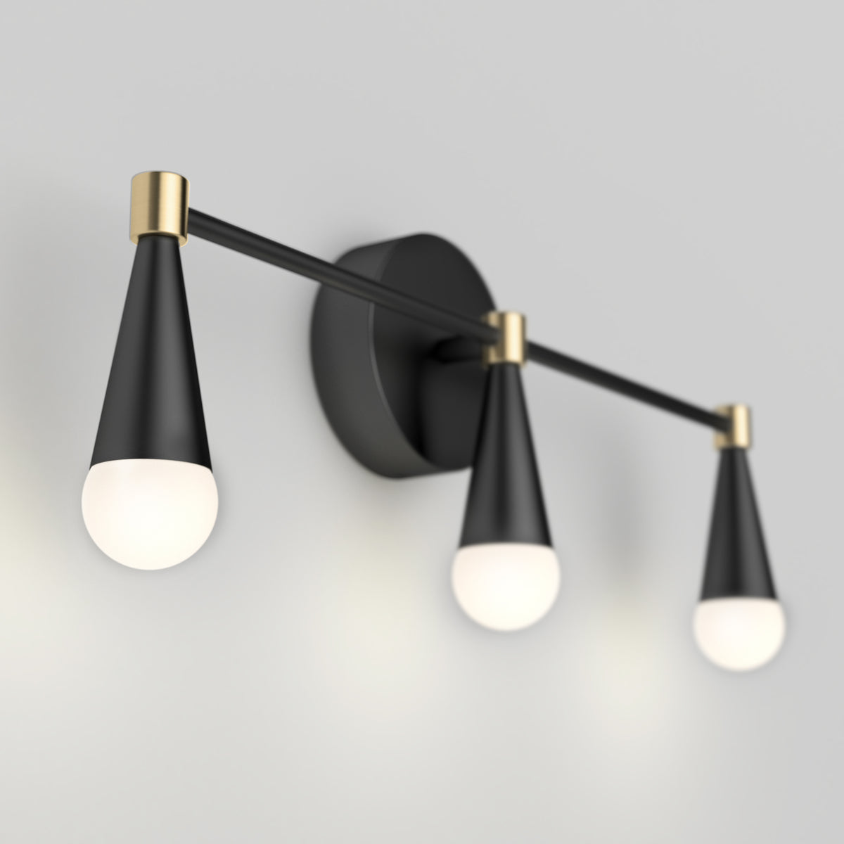 The Artika Wayden LED mid-century vanity light features three black and gold cone fixtures with round white bulbs.