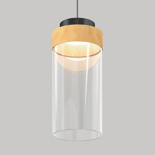 The Artika Hanson 1-light LED pendant 5 CCT features a cylindrical clear glass shade, light wood accent top, and black mount, suspended from the ceiling against a plain gray background.