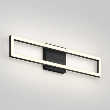 The Artika-CAN-dev Dover modern LED bathroom vanity light 5 CCT features a black central base and open rectangular frame with glowing LED, mounted on a plain light-colored wall.