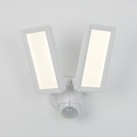 The Artika Sentinel outdoor Flat Panel Security light features two rectangular LED panels and a motion sensor below, all in a sleek white housing mounted on a white wall.
