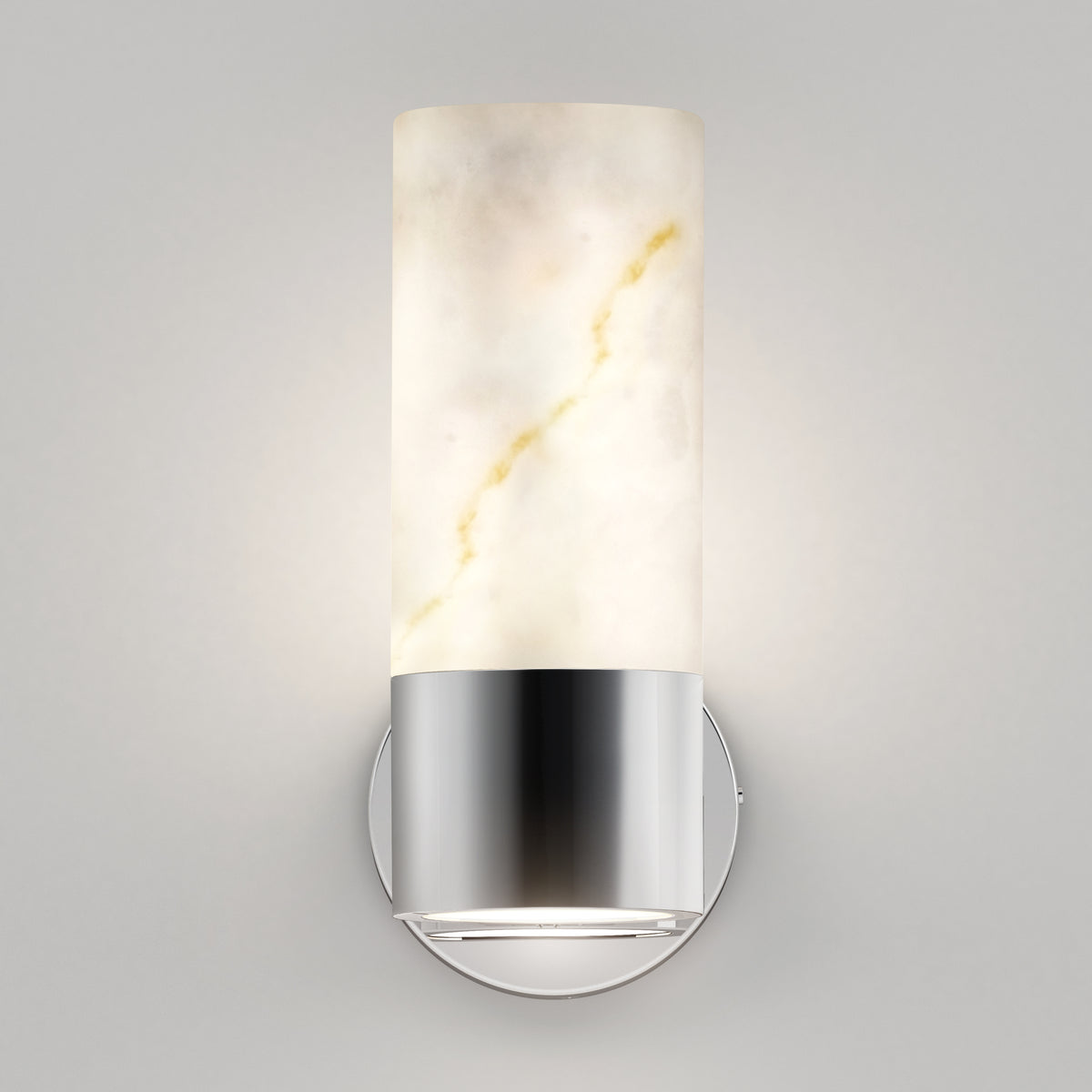 A modern wall sconce featuring a cylindrical, marble-like frosted glass shade with subtle gold veins, mounted on a round, metallic silver base against a neutral gray wall.