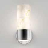 A modern wall sconce featuring a cylindrical, marble-like frosted glass shade with subtle gold veins, mounted on a round, metallic silver base against a neutral gray wall.
