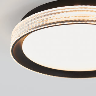 Close-up of the Artika Aston 15 in. LED modern flush mount light 5 CCT, featuring a textured, translucent outer ring and smooth, glowing LED center, mounted on a white ceiling.