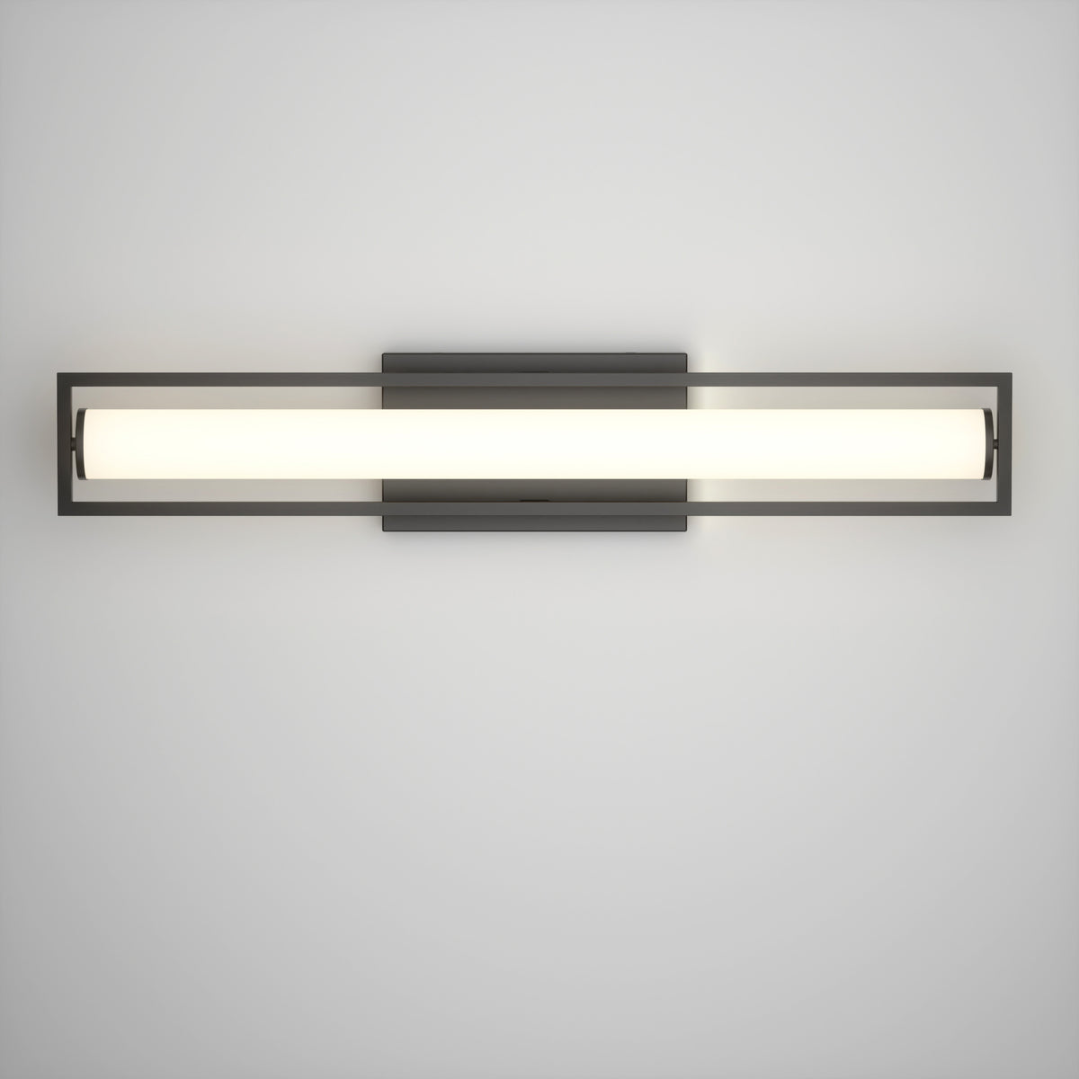 A modern wall-mounted light fixture with a long, horizontal, cylindrical white light encased in a rectangular black metal frame, attached to a square black base on a plain white wall.