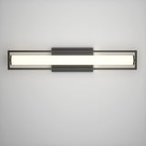 A modern wall-mounted light fixture with a long, horizontal, cylindrical white light encased in a rectangular black metal frame, attached to a square black base on a plain white wall.