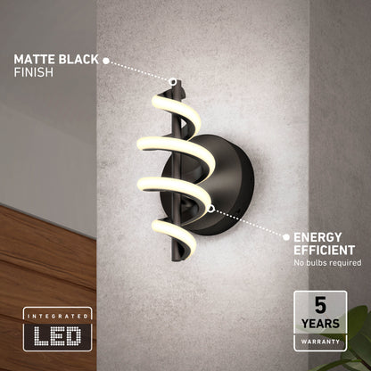 The Artika Chorus LED Wall Light features a matte black finish and spiral-shaped integrated LED, mounted on a light gray wall. It stands out for its energy efficiency and comes with a 5-year warranty.