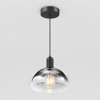 The Artika Nella Pendant without Bulbs features a clear glass dome shade, black metal fixture, and hangs from a black cord against a plain white background.
