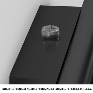 Close-up of a round, clear integrated photocell on the sleek black Bowen modern LED outdoor address wall light 5 CCT by Artika. Text below reads: INTEGRATED PHOTOCELL / CELLULE PHOTOSENSIBLE INTÉGRÉE / FOTOCÉLULA INTEGRADA.