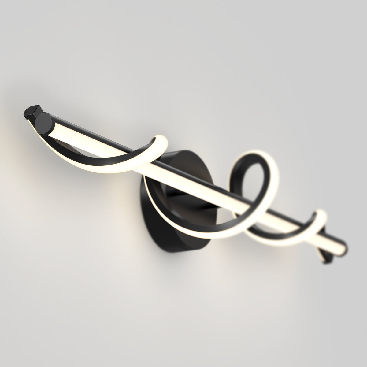 A modern wall sconce with a black base and a curved, glowing LED light bar looping around itself, mounted on a light gray wall.