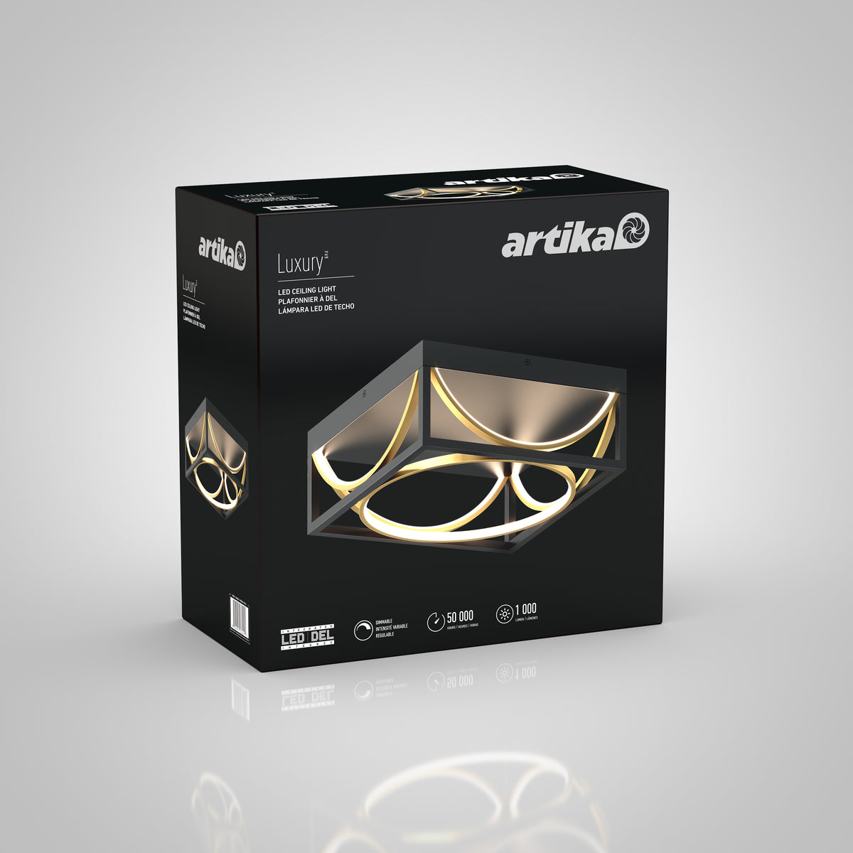 A black box with Artika Luxury+ branding displays a modern LED ceiling light with geometric ring designs, glowing with warm light. Product details and icons are shown on the packaging.