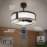 Modern ceiling fan with matte black finish and integrated LED light. Remote control shown, labeled as remote controlled, energy efficient, with a 5-year warranty. The fan is mounted on a white ceiling above a wooden wall.