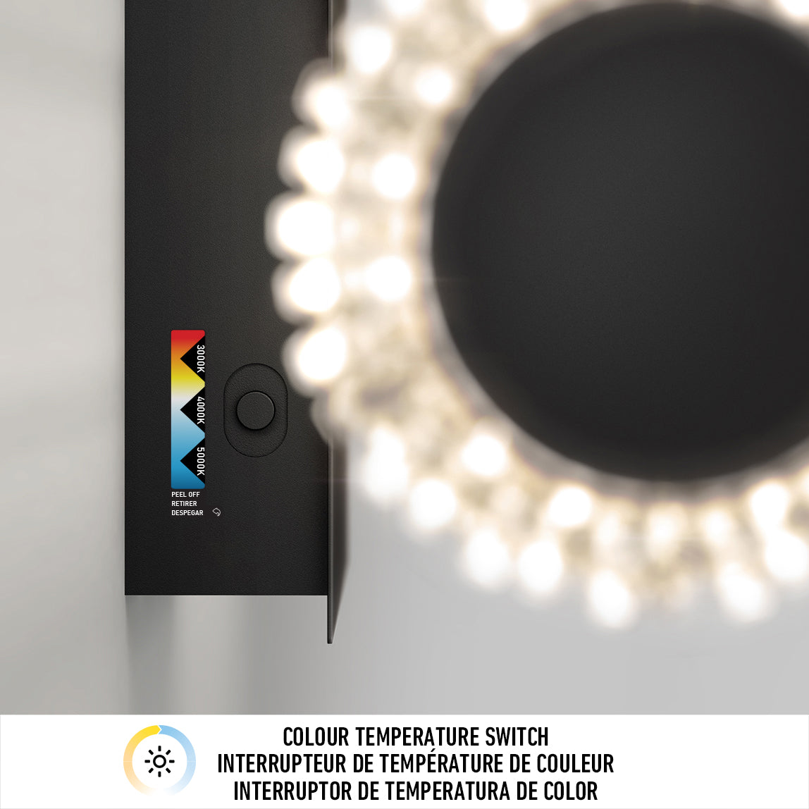 Overhead view of a black circular light fixture with a glowing ring of bulbs. Next to it is a color temperature switch with options labeled warm, neutral, and daylight. Text below reads Colour Temperature Switch in three languages.