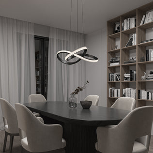 Modern dining room with a dark oval table, six light upholstered chairs, the Artika Morgan LED contemporary pendant light 5 CCT, sheer curtains, a glass vase with branches, and a wooden bookshelf filled with books.