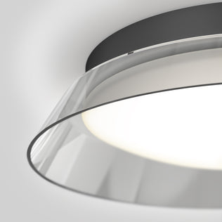 Close-up view of the Arthur modern LED flush mount light 5 CCT by Artika, featuring a circular black base and a translucent curved shade surrounding a glowing white LED.