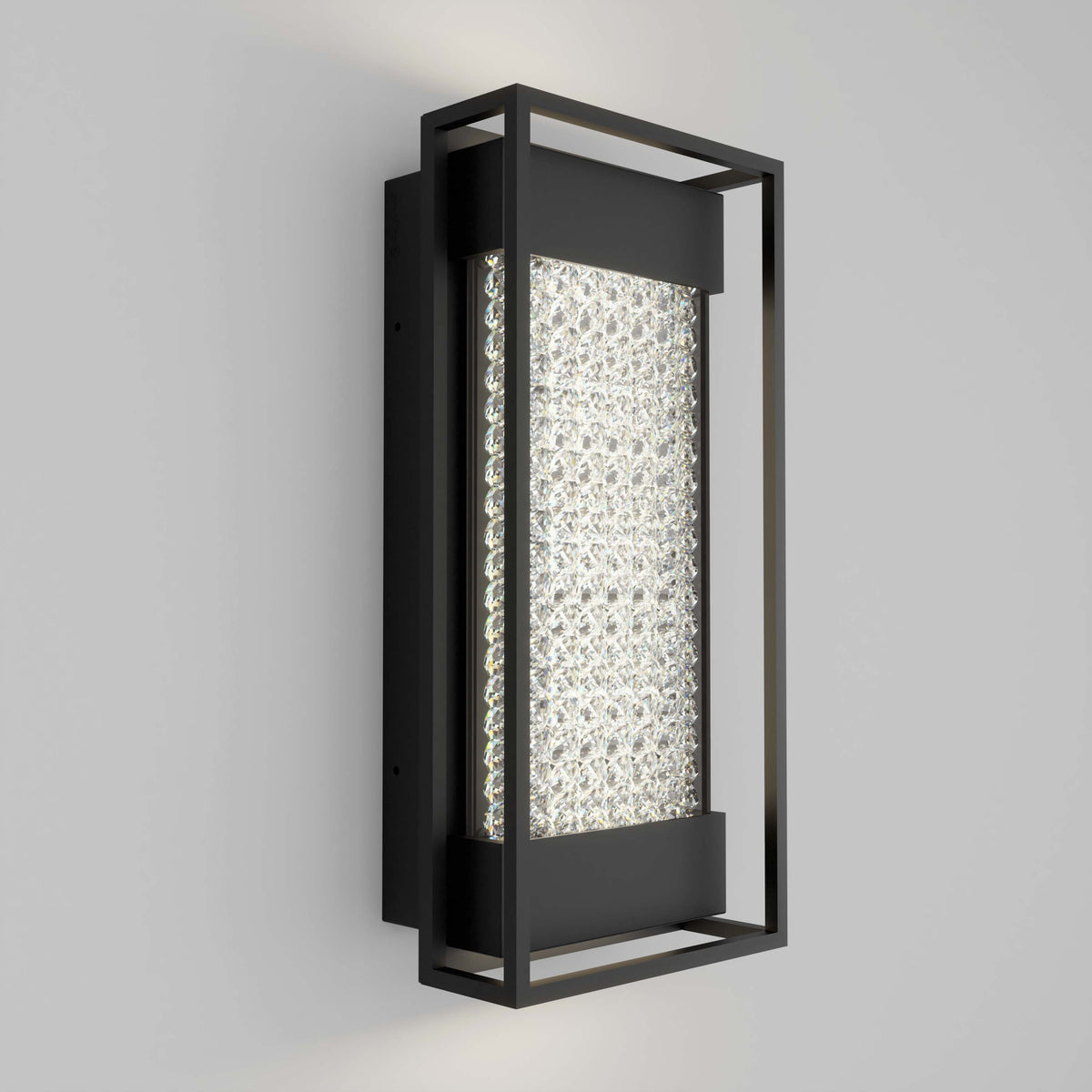 The Artika Glam indoor-outdoor LED wall light features a black metal frame and textured illuminated glass center, creating a modern look on any light gray wall.