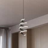 A modern spiral pendant light with integrated LED glows warmly, hanging from the ceiling in a minimalist room with light wood cabinets and white curtains.