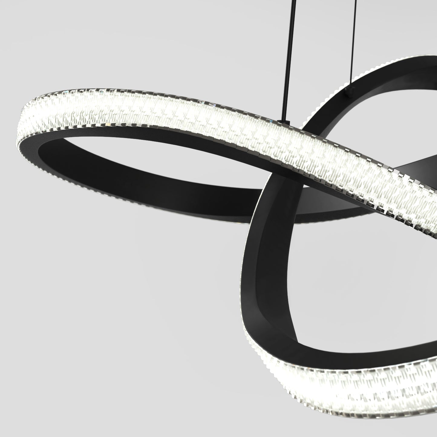 The Artika Morgan LED contemporary pendant light 5 CCT features modern interlocking black rings with integrated textured lights, suspended by thin wires against a plain light gray background.