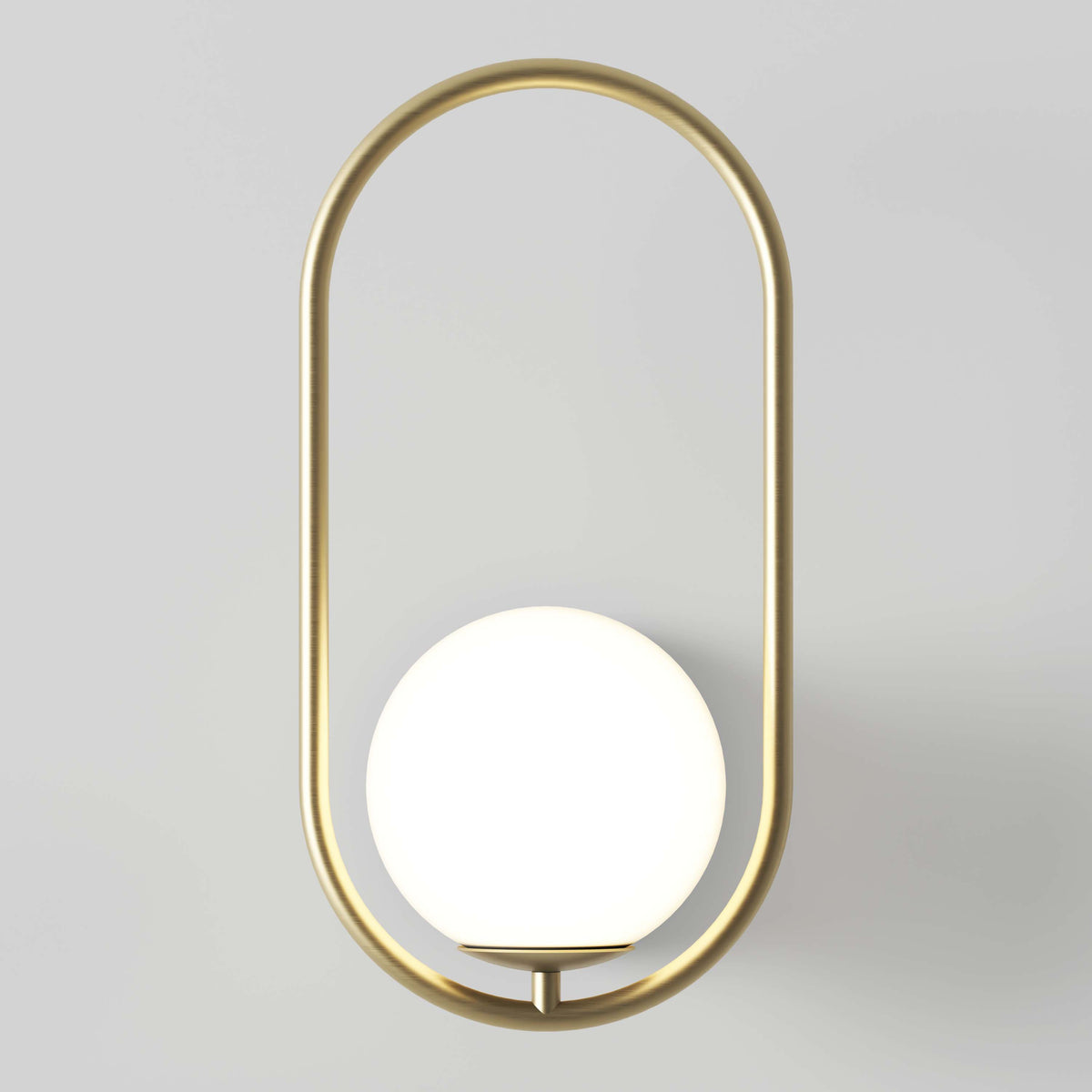 The Artika Bloom LED Sconce 3 CCT showcases a round white globe light set inside a vertical, oval gold metal frame, creating a modern accent against any light gray wall.