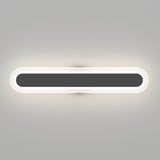 A modern, horizontal, oval-shaped wall light fixture emits a soft white glow against a plain gray wall. The center is dark, framed by a bright illuminated border.