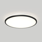 A round, modern ceiling light fixture with a black rim and a white, illuminated center, mounted on a light gray ceiling.