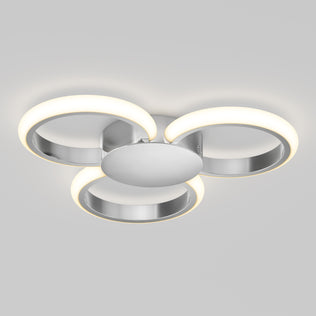 The Artika Nyala 15 in. LED flush mount light features three circular LED rings emitting soft white light, arranged in a triangular pattern on a central metallic base.