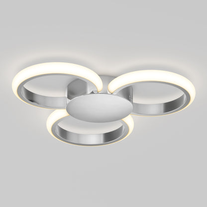 The Artika Nyala 15 in. LED flush mount light features three circular LED rings emitting soft white light, arranged in a triangular pattern on a central metallic base.