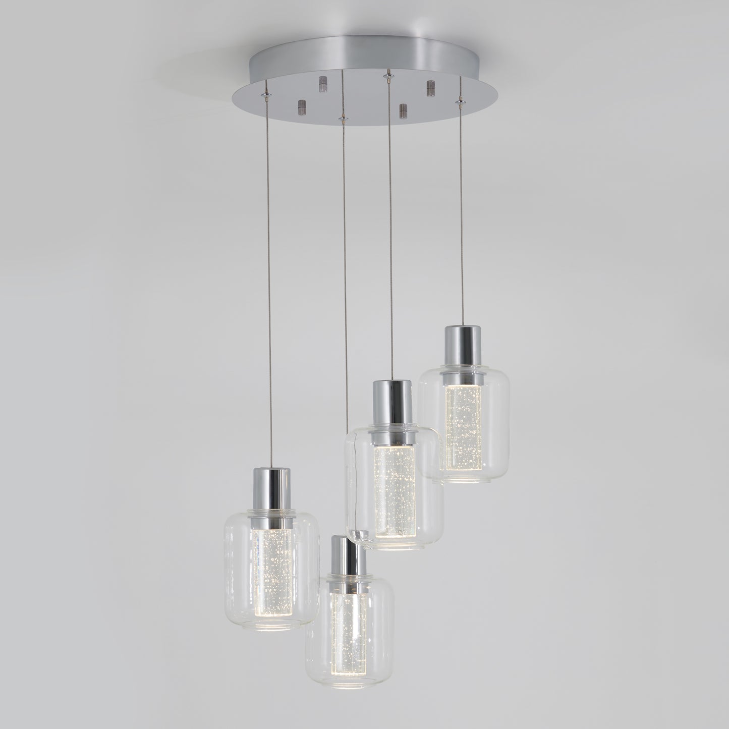 The Artika Champagne Globe 4-light LED pendant features four cylindrical glass lights, each suspended at varying heights from a round metallic base, with bright sparkling inner cores for a modern look.