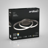 A black box featuring the Artika Salto LED ceiling light with circular, overlapping rings on the front. The packaging displays specifications and icons for brightness, lifespan, and warranty.