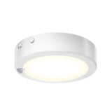 A round, white LED ceiling light fixture with a smooth surface and a soft glowing center, featuring a small sensor on the side.