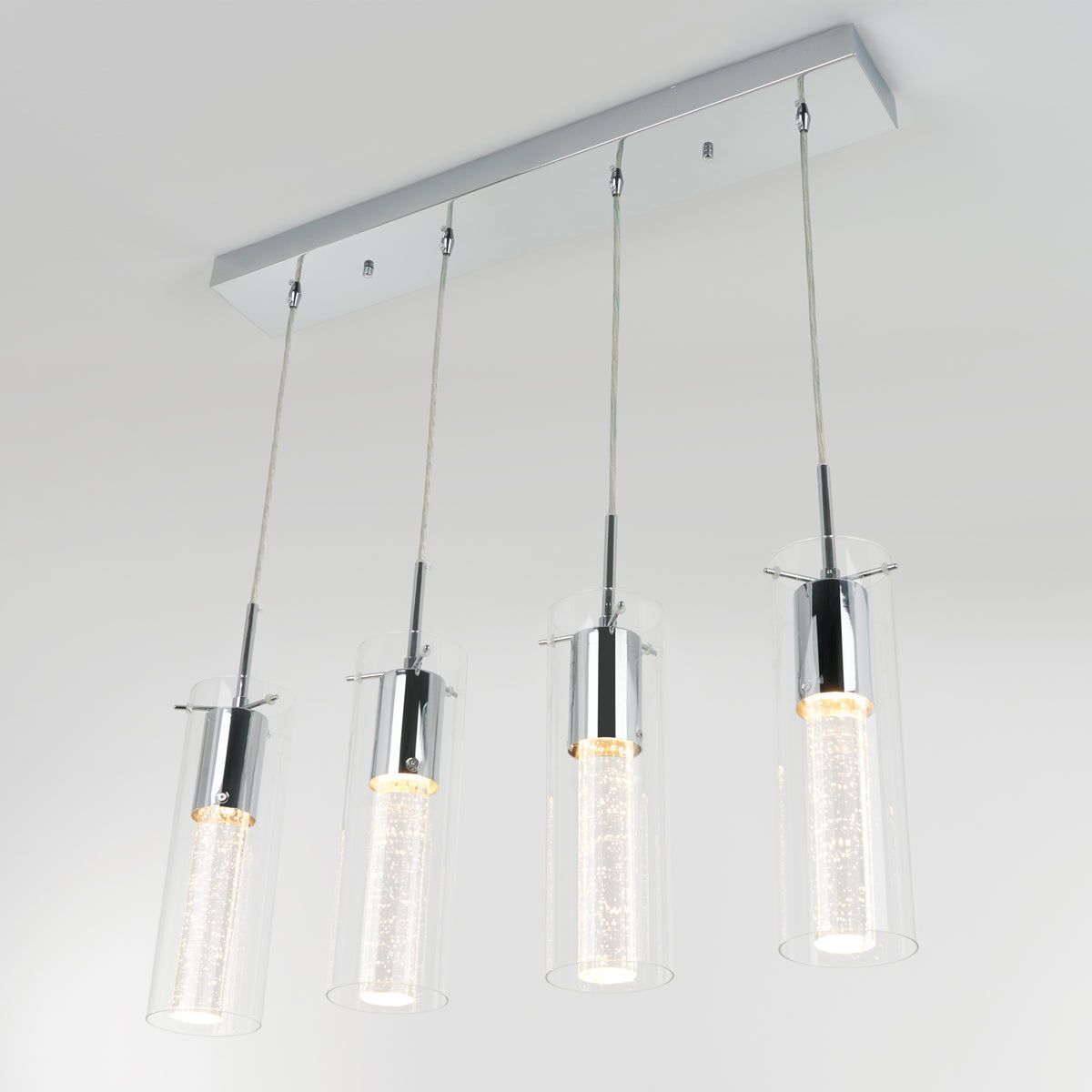 The Artika Bubble Flow 4-light pendant features four cylindrical glass shades, each with an LED bulb, suspended from a rectangular chrome base for a modern ceiling lighting solution.