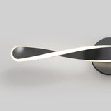 Minimalist wall light fixture with a black, twisted ribbon design and a glowing white edge, mounted on a round base against a plain gray background.