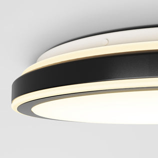 Close-up view of the Artika Altitude 15 in. LED modern flush mount light with 5 CCT, featuring black and white rings and built-in LED lighting, mounted on a white ceiling.