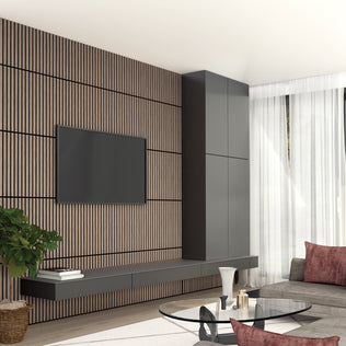 Modern living room with a wall-mounted TV on an Artika Sonolok 15.5 ft sound-absorbing wall panel kit, floating black console, tall black cabinet, gray sofa with burgundy pillows, glass coffee table, potted plant, and sheer white curtains.