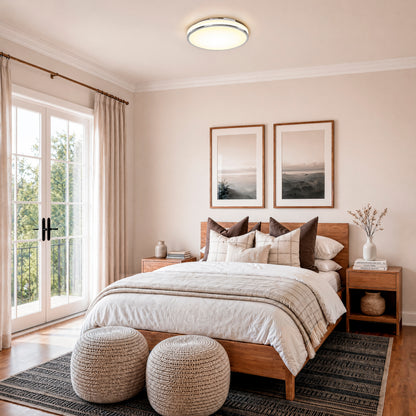 Modern bedroom featuring Artika’s Summit 15 in. LED Flush Mount 5CCT ceiling light, wooden bed, cozy bedding, and natural light.