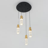 A modern ceiling light fixture with four hanging pendant lights, each featuring a cylindrical glass shade, gold accents, and a black circular base against a plain white background.