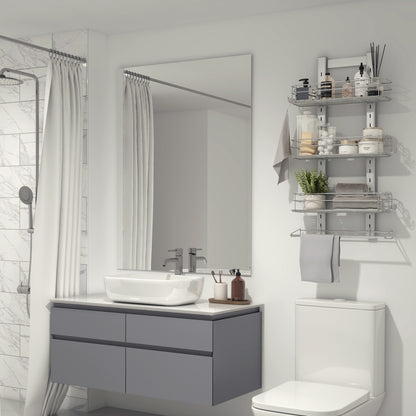 Modern bathroom with a large mirror, gray floating vanity, vessel sink, white toilet, marble-tiled glass shower, and the Artika Camden Shower Caddy for organizing toiletries and towels.