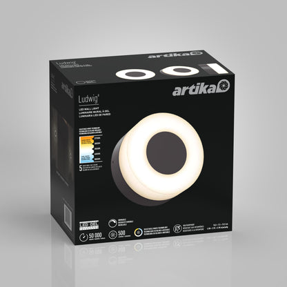 A black Artika box showcases the Ludwig modern LED indoor-outdoor wall light 5CCT with a glowing circular design. Key features like adjustable color temperature, brightness, and lifespan are printed on the packaging.