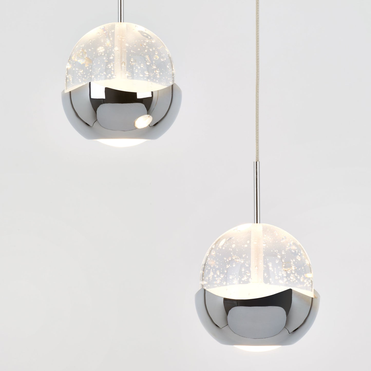 The Artika-CAN-dev Oracle modern 5-light LED pendant features chrome-finished spherical shades with translucent, bubble-speckled upper halves, shown suspended against a plain white background.