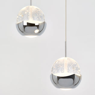 The Oracle modern 5-light LED pendant by Artika features spherical lights with a half-chrome, half-opaque speckled frosted design, suspended from the ceiling and displayed against a plain white background.