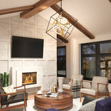 A modern living room with a vaulted ceiling, exposed wooden beams, a wall-mounted TV, a lit fireplace, a round wooden coffee table, gray armchairs, large windows, and a geometric pendant light.
