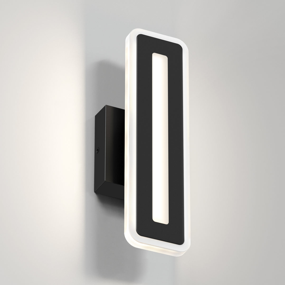 The Artika Evasion modern indoor-outdoor LED wall light 3 CCT features a black rectangular frame with a glowing white LED outline and hollow center, mounted on a black base against a light gray wall.