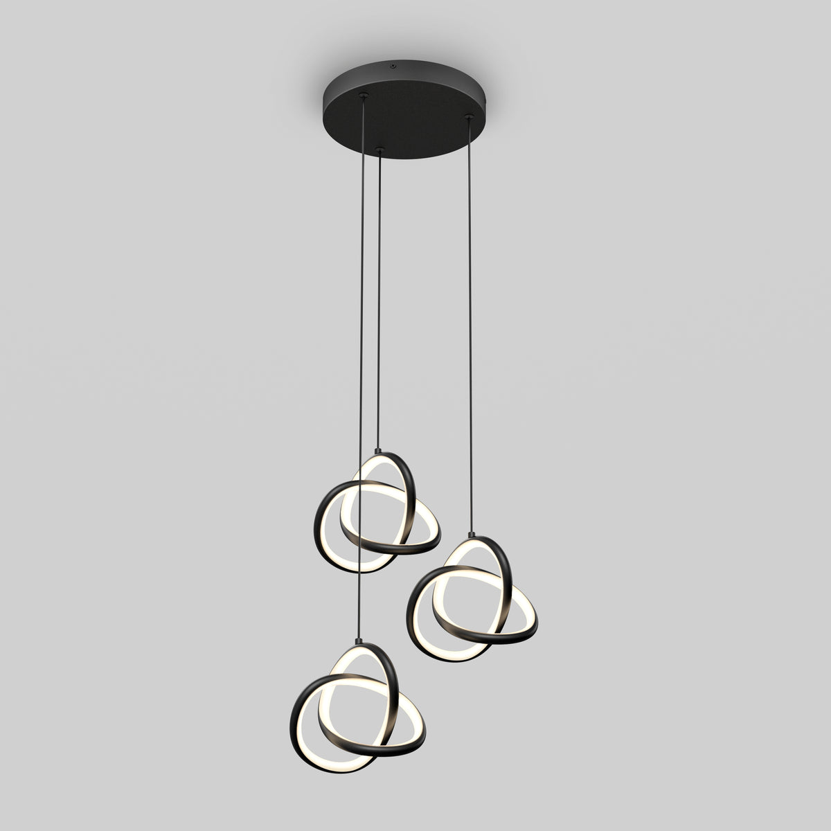 Modern ceiling pendant light with three hanging loops of black and white LED rings, suspended at varying heights from a round black base against a light gray background.