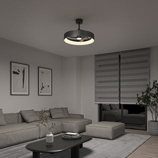 A modern living room features a gray sectional sofa, abstract wall art, a black coffee table, a potted plant, layered blinds, and is illuminated by the Artika Austin 23 in. LED modern ceiling fan with remote.