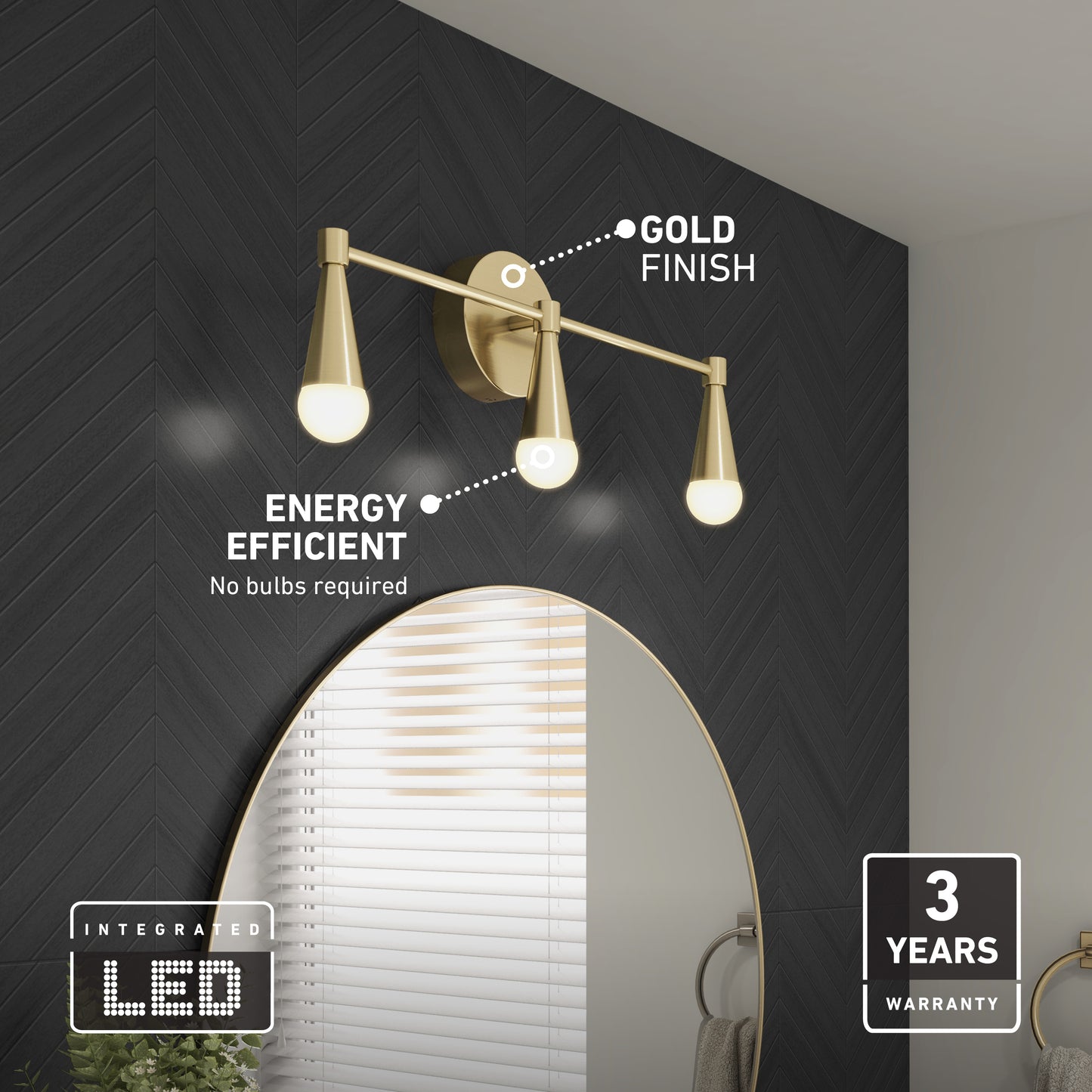 The Artika Wayden LED mid-century bathroom vanity light in a gold finish is mounted above a round mirror on a dark herringbone wall. Labels highlight Gold Finish, Energy Efficient, and 3 Years Warranty.